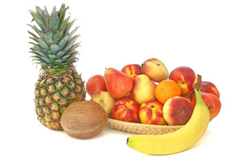 Tropical fruit in a wicker plate isolated on white background