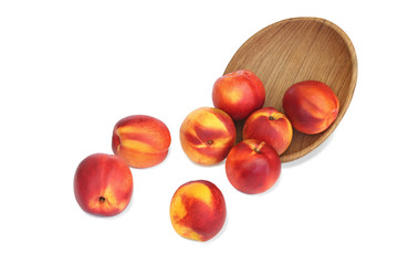 Scattered nectarines from the plate isolated on white background