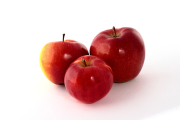 Three red apples on a white background