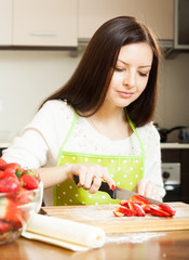 girl cuting strawberry