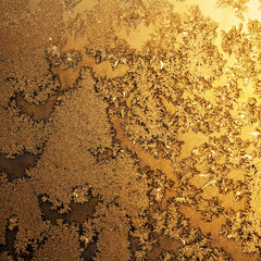 Snowflakes and ice on frozen window