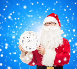 man in costume of santa claus with clock