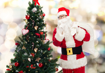 santa claus with bag and christmas tree