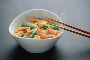 hot noodles with shrimps on a black background