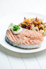 Grilled Salmon with Fresh vegetables on white background
