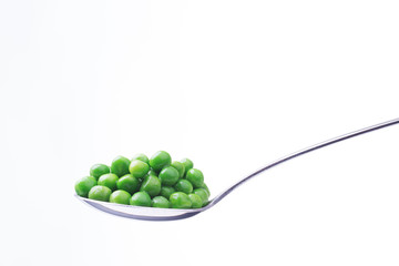 spoon with peas isolated on white background