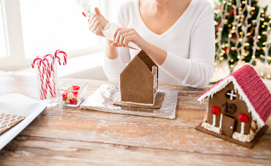 close up of woman making gingerbread houses