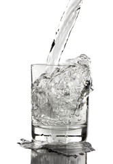 puring water on a glass on white background