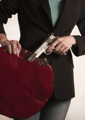 Woman hides a gun in her purse