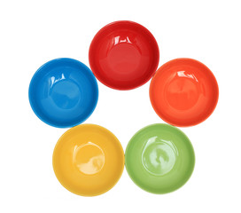 Row with five colorful bowls isolated over white