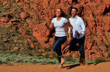 Young Couple Running on a Sand Dune