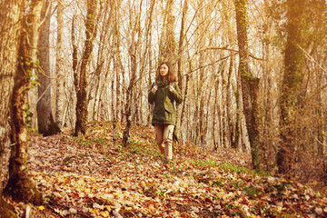 Fototapeta premium Young hiker woman walking in autumn forest