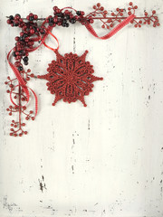 Red and white Christmas ornaments on vintage white wood