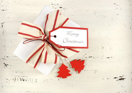 Red and white Christmas ornaments on vintage white wood