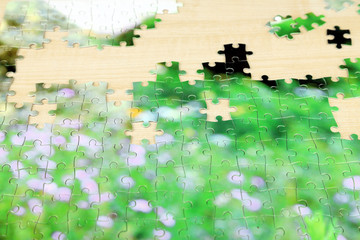 Puzzles with beautiful landscape on wooden background