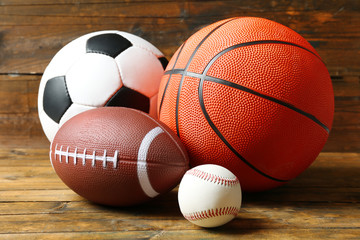 Sports balls on wooden background