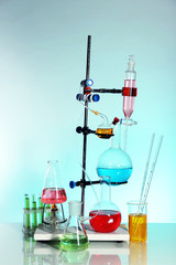 Fototapeta na wymiar Laboratory glassware on light blue background