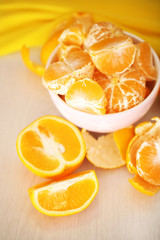 Fototapeta na wymiar Sweet tangerines and oranges on table close-up