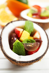 Fruit salad in coconut on table