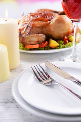 Delicious baked chicken on plate on table on light background