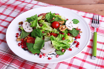 Fresh salad with greens, garnet and spices