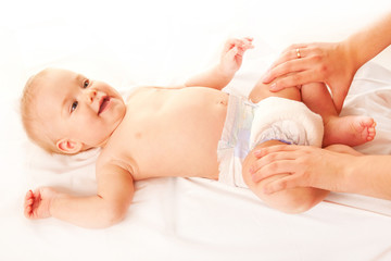 Obraz na płótnie Canvas Baby massage. Mother massaging kid legs