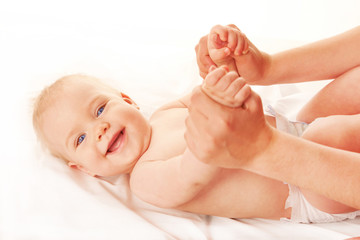 Baby massage. Mother massaging kid hands