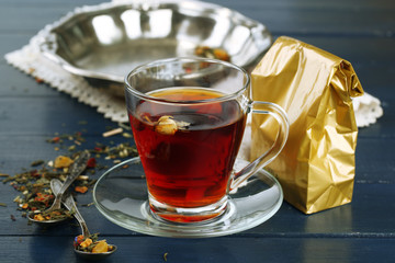 Beautiful vintage composition with herbal tea, on wooden table