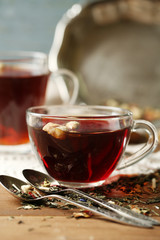 Beautiful vintage composition with herbal tea, on wooden table