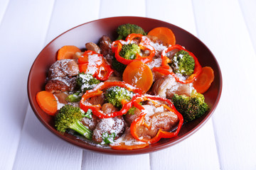 Braised wild mushrooms with vegetables and sauce in plate