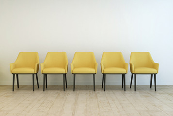 Row of empty chairs against a wall