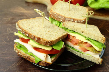 Sandwiches with fresh vegetables ham and cheese