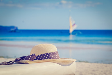 hat on tropical sand beach