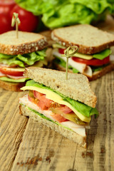 Tasty sandwiches with ham, cheese and fresh vegetables