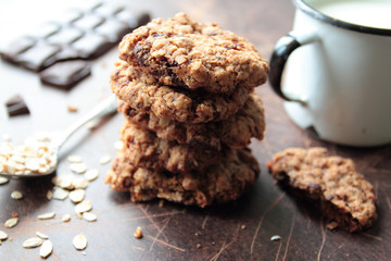 Cookies with chocolate and raisin with mug of milk
