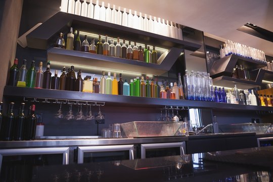 Close up on bar with bottle in a line