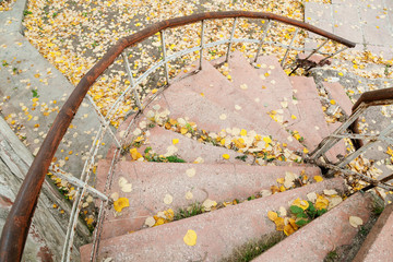 Abandoned grungy stairs with railings in autumn