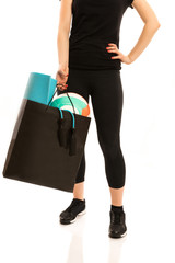Woman standing with shopping bag full of sports equipment