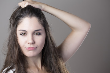 Naklejka premium Portrait of a young brunette woman making faces with different e