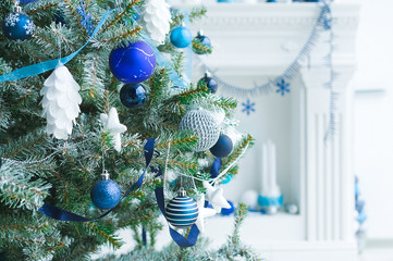 Christmas tree with blue and white toys in the interior
