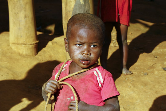 Poor african boy with a string - is he trying to attempt a suici