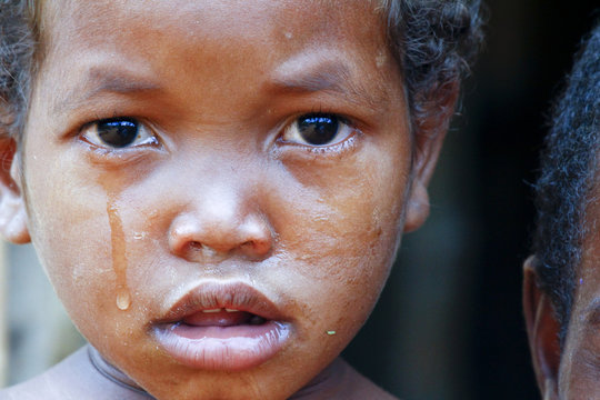 Crying girl with tear on cheek - poor african child