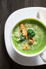 Broccoli cream soup with walnuts and parmesan