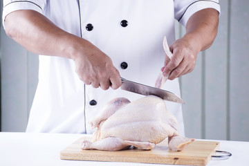 Chef prepared chopping raw chicken