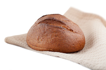 black round bread lying on a towel