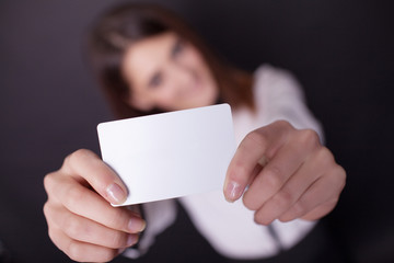 Gift card. Excited woman showing empty blank paper card sign wit