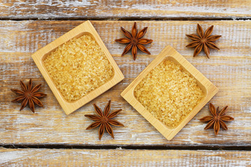 Brown sugar and star anise on rustic wooden surface