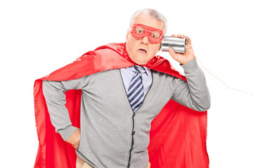 Shocked senior superhero with a tin can phone © Ljupco Smokovski