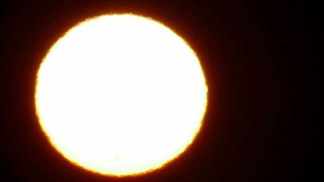 Sun with sunspots, telescope view, slow motion