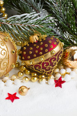 Fototapeta na wymiar christmas red and golden heart with evegreen tree